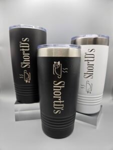 ShortD's 20 oz stainless steel tumbler featuring the signature logo, designed for keeping coffee hot or cold on the go.