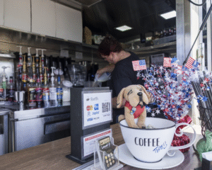 Dawnn from ShortD's pouring coffee for a waiting customer.